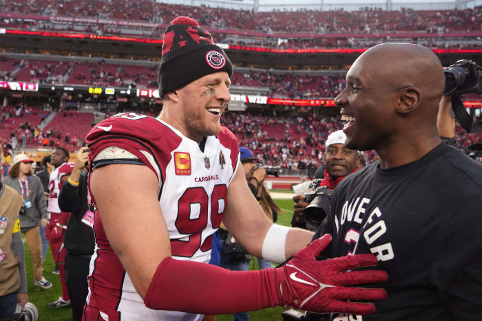 J.J. Watt and DeMeco Ryans embrace on the field after a game during the 2022 season. 